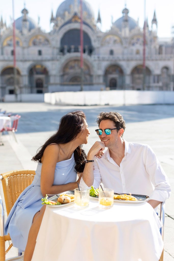 Couple enjoying coffee at a quaint café in St Mark's Square in Venice