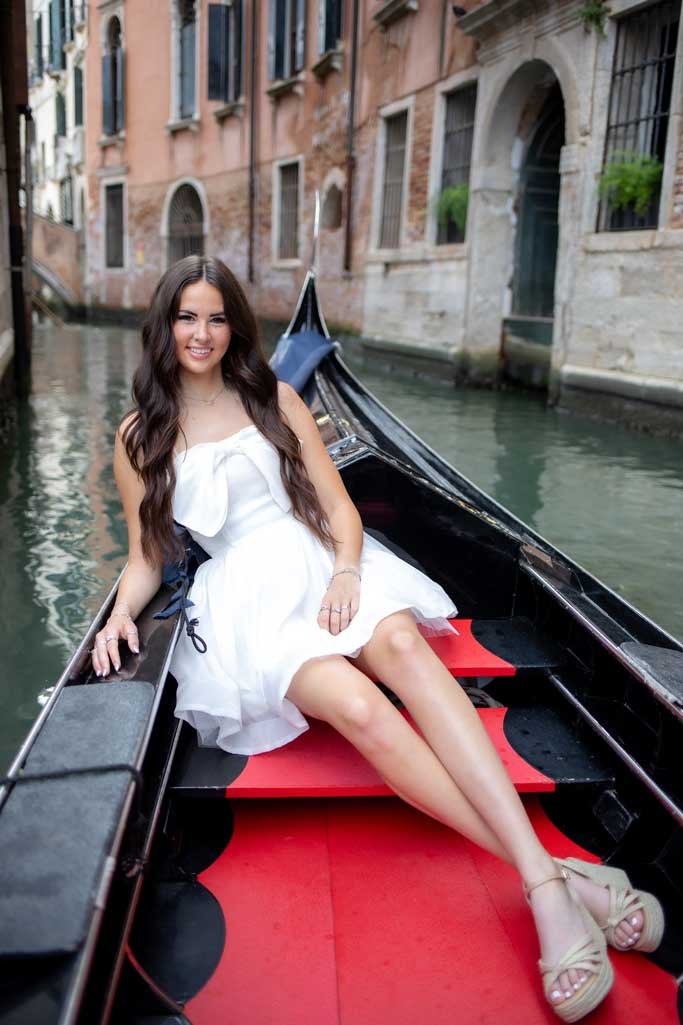 Senior photo with gondola and canal backdrop in Venice