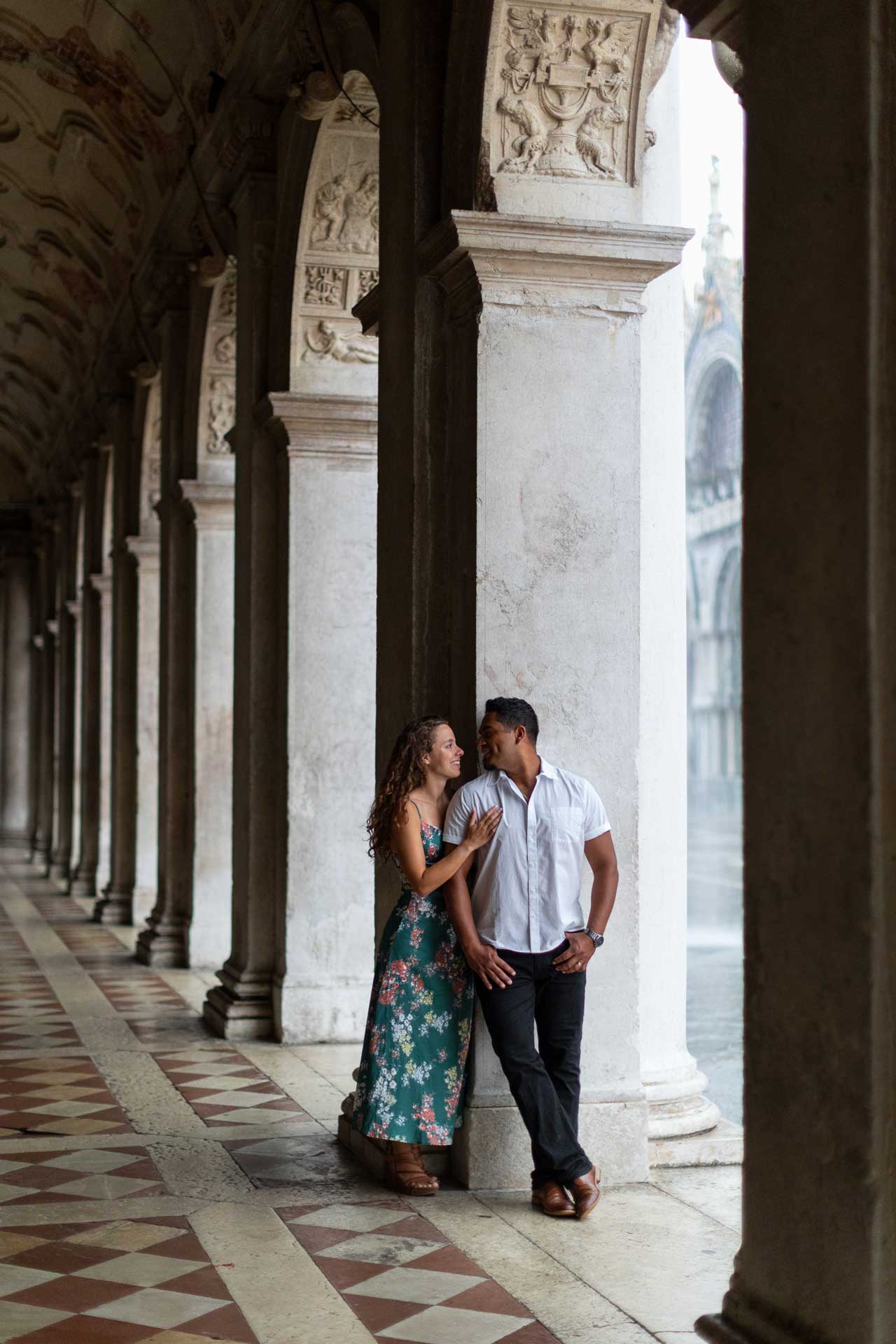 Couple engagement in Venice unde the arches of st. mark square