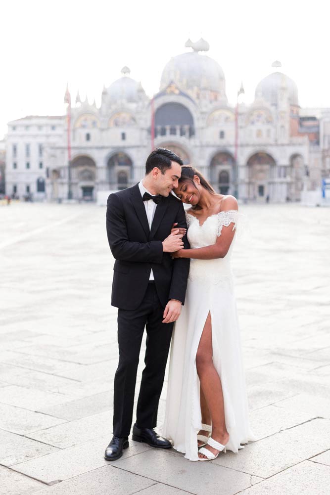 Bride and Groom hug in St. Mark's Square in Venice, Italy