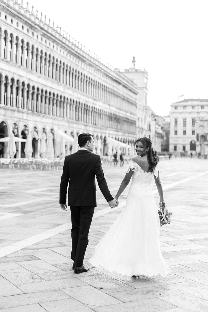 Wedding couple walking in St. Mark's Square in Venice, Italy